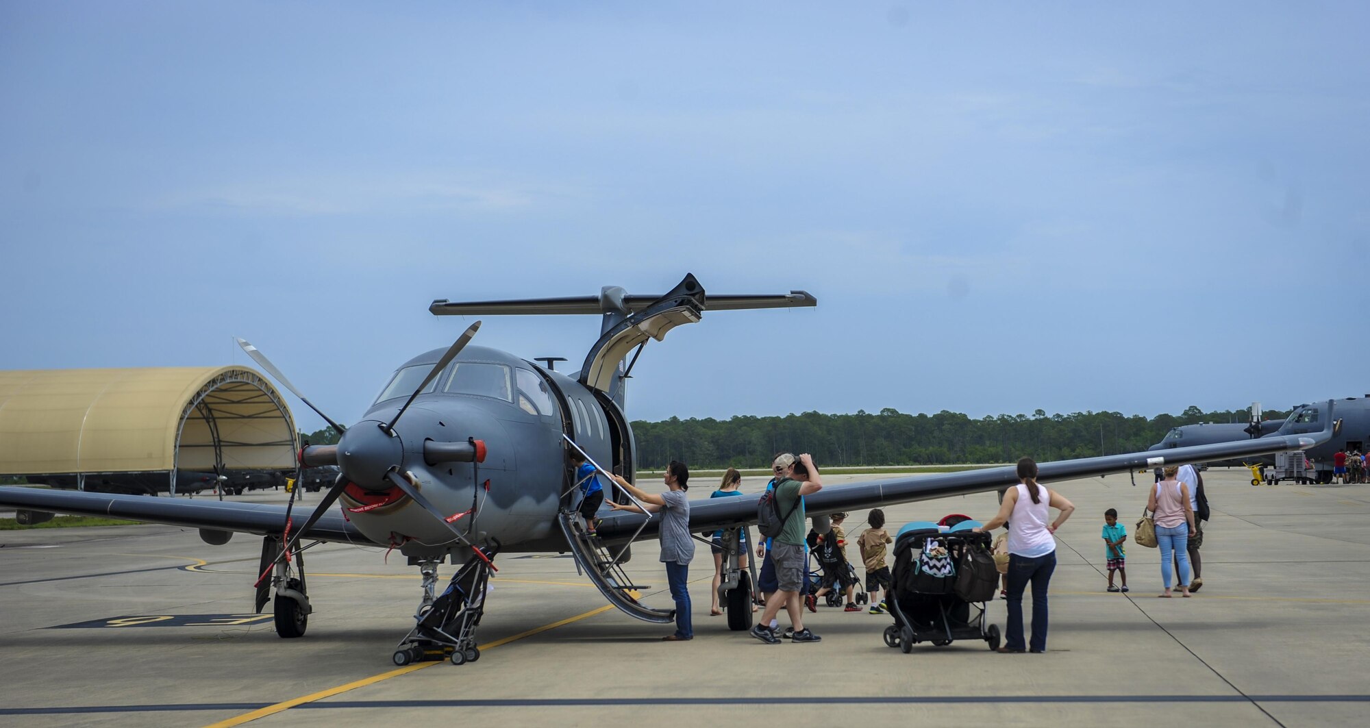 Families tour a U-28A during Operation Kids Understanding Deployment Operations at Hurlburt Field, Fla., April 30, 2016. The School Liaison Program hosted KUDOS to educate kids on the deployment process, engaging them in activities that help show children similar situations their parents go through during pre-deployment. After a “homecoming” families were able to explore aircraft on the flightline. (U.S. Air Force photo by Senior Airman Meagan Schutter)