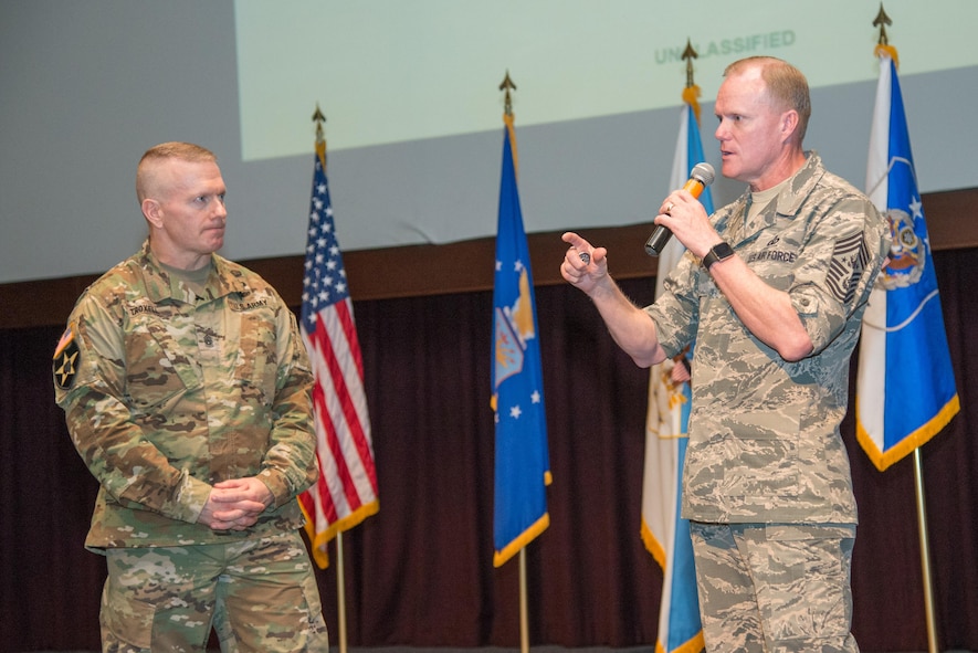 Command Sgt. Maj. John Wayne Troxell speaks to the Chief Master Sgt. of the Air Force James A. Cody at the Senior Non Commissioned Officer Academy during the Senior Enlisted Leader Summit at Maxwell Air Force Base, April 18, 2016.  The command chief master sergeants, career field managers, professional military education commandants and other key senior enlisted leaders from across the total-force spectrum participated in a panel discussion with several former chief master sergeants of the Air Force, the chief of staff of the Air Force and the senior enlisted adviser to the chairman of the Joint Chiefs of Staff.