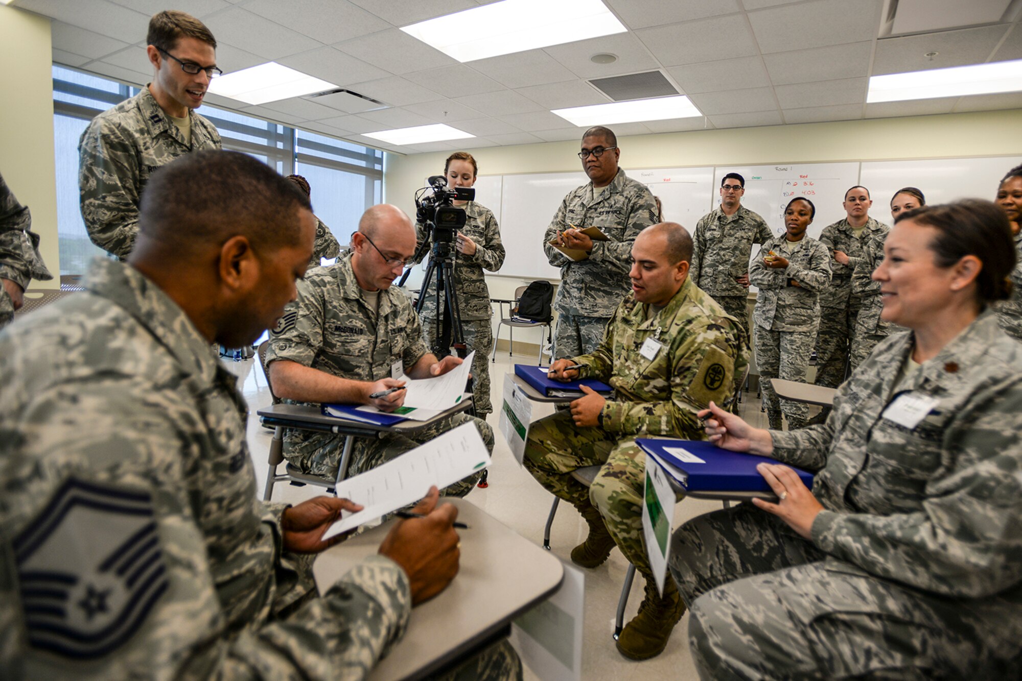 Students simulate checking in and tracking patient movements in a mock clinic during the Gateway Academy's "Seven Wastes" class April 26, 2016, at the San Antonio Military Medical Center on Joint Base San Antonio-Fort Sam Houston, Texas. The goal of the Seven Wastes class was to find ways to eliminate wasted time during appointments which would help enhance patient care. (Courtesy photo)