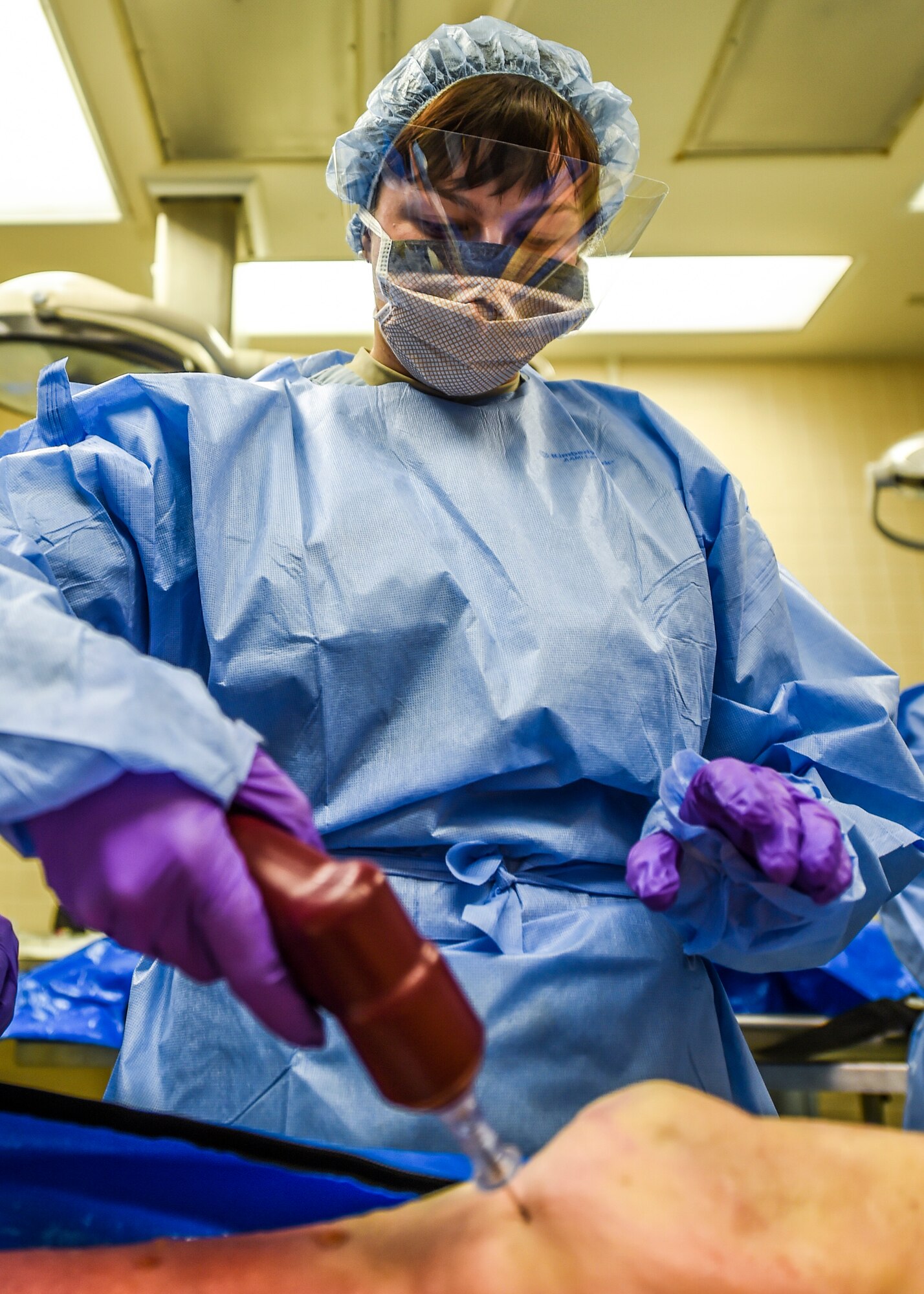 Staff Sgt. Reginald Gilchrist, NCO in charge of the Sustainment for Trauma and Resuscitation Skills Program, teaches Airman 1st Class Kasey Bober how to palpate for proper placement of intraosseous needle prior to fluid therapy April 21, 2016 at the Wilford Hall Ambulatory Surgical Center on Joint Base San Antonio-Lackland, Texas. Bober is an aerospace medical technician with the 59 MDOS at JBSA Lackland. (U.S. Air Force photo/Staff Sgt. Michael Ellis)