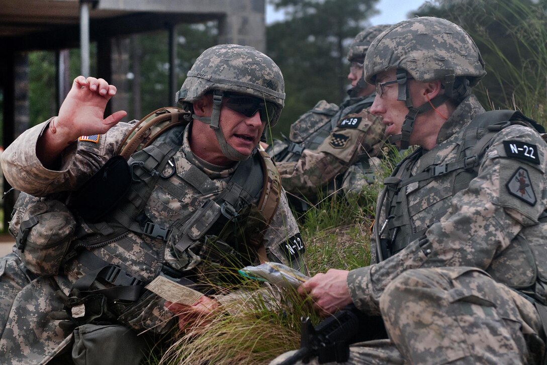 Army Staff Sgt. Orval Emery, left, and Army Sgt. Andrew Crane discuss strategies while preparing for the squad tactics lane during the annual Army Reserve Best Warrior Competition at Fort Bragg, N.C., May 5, 2016. Emery is assigned to the 75th Training Command and Crane is assigned to the U.S. Army Reserve Legal Command. Army photo by Sgt. Darryl L. Montgomery