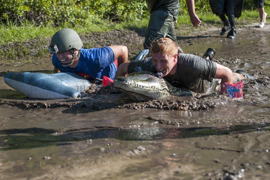 U.S. Air Force Airman Daniel Snider, 23d Wing photojournalist, left, and Tech. Sgt. Zachary Wolf, 23d Wing NCO in charge of media operations, right, swim using inflatables during the 2016 Moody Mudder, May 7, 2016, in Ray City, Ga. During the race, runners wore costumes and carried props to show their spirit. (U.S. Air Force photo by Airman 1st Class Lauren M. Hunter/Released)