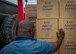 A charity worker on the ground in Grand Goave, Haiti accepts Denton Program humanitarian cargo after members of the 701st Airlift Squadron delivered about 700,000 pounds of cargo to the island nation April 21.  (U.S. Air Force photo by Senior Airman Tom Brading)