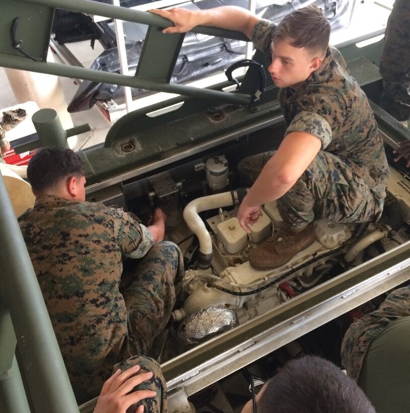 Lance Corporal Gilberto Salazarvalladolid, Private First Class Korey Gaver, and Corporal Austin Bernal, Marines attached to Small Craft Mechanics course 3-16 (SCMC 3-16); conduct Preventative Maintenance Checks and Services (PMCS) on the Bridge Erection Boat (BEB) as part of a practical application. These students are replacing the fuel lubricity filter.
