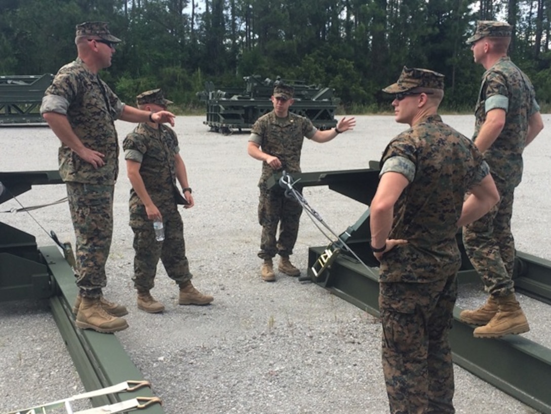 On May 4, 2016 Gunnery Sergeant Timothy Stringer, an instructor with Combat Engineer Instruction Company (CEIC); instructs students of Combat Engineer Officer course 5-16 (CEO 5-16) on standard bridge assembly aboard Camp Lejeune, N.C. Marine Corps Combat Engineers are capable of configuring and assembling these bridge parts to cross a gap. Pictured from left to right are Gunnery Sergeant Timothy Stringer, and Second Lieutenants Brock Yackey, Troy Searcy, Thomas Cofer, and Nicholas Downey.  