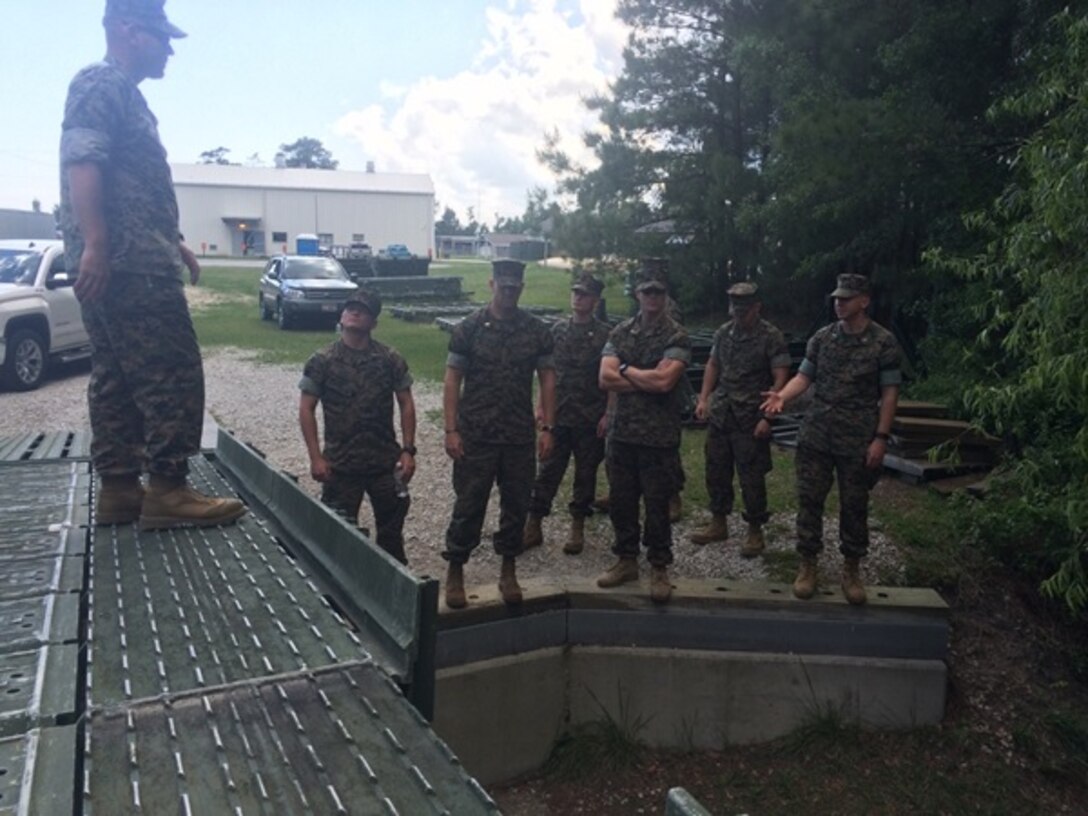 On May 4, 2016 Gunnery Sergeant Timothy Stringer, an instructor with Combat Engineer Instruction Company (CEIC); teaches students of Combat Engineer Officer course 5-16 (CEO 5-16) about the Medium Girder Bridge. The Medium Girder Bridge provides Marines a fast and effective means to cross a wide variety of gaps. Pictured left to right: Gunnery Sergeant Stringer, Second Lieutenants Brock Yackey, Justin Wilkison; First Lieutenant Jonathan Lanning Keller, and Second Lieutenants Thomas Cofer, Troy Searcy, and Nicholas Downey.  
