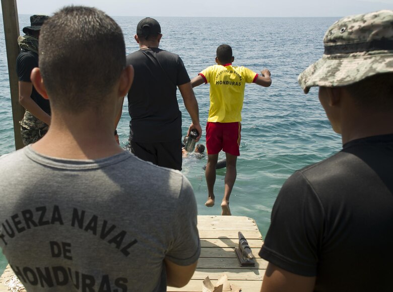 An enlisted Honduran Navy trainee jumps in the water during a swimming aptitude test April 4, 2016, on the northern coast of Honduras. The trainees took part in the first ever consolidated infantry training program in the Navy, giving them a common set of skills and knowledge to pull from in the future. (U.S. Air Force photo by Capt. Christopher Mesnard)