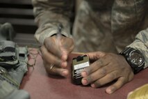 U.S. Air Force Staff Sgt. Jonathan McCullough, an 8th Operations Support Squadron aircrew flight equipment journeyman assigned to Kunsan Air Base, Republic of Korea, signs a service date on a strobe light, May 2, 2016, at Eielson Air Force Base, Alaska. Strobe lights are used to signal for rescue once the pilot has ejected and is awaiting extraction. (U.S. Air Force photo by Staff Sgt. Ashley Nicole Taylor/Released)