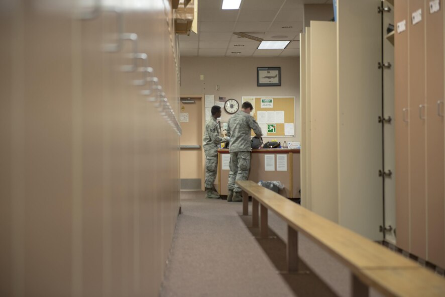 U.S. Air Force Staff Sgt. Jonathan McCullough and Senior Airman Daniel Godfrey, 8th Operations Support Squadron aircrew flight equipment (AFE) journeymen assigned to Kunsan Air Base, Republic of Korea, perform a daily inspection on flight equipment, May 2, 2016, at Eielson Air Force Base, Alaska. AFE technicians must perform extensive work on each piece of equipment to ensure maximum safety for pilots. (U.S. Air Force photo by Staff Sgt. Ashley Nicole Taylor/Released)