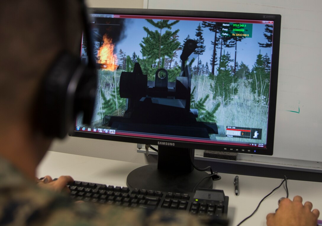 A U.S. Marine with II Marine Expeditionary Force G7 conducts a mission on Virtual Battlespace 3, while receiving support from a Joint Terminal Attack Controller during Emerald Warrior aboard Camp Lejeune, N.C., May 4, 2016. Simulation centers from Charleston Air Force Base, S.C., Eglin AFB, F.L., Cannon AFB, N.M. and Distributed Training Operations Center, I.A. all took part in Emerald Warrior providing various support assets vital to the JTACs mission of bringing the air element to the ground element. (U.S. Marine Corps photo by Cpl. Justin T. Updegraff/ Released)