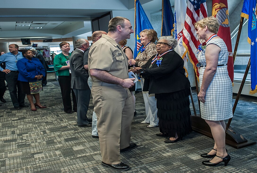 Defense Logistics Agency Land and Maritime Hall of Fame Class of 2016 Inductees greet colleagues, friends, and family members during a reception in the Building 20 Buckeye Room at Defense Supply Center Columbus. Pictured (r-l) are Patricia Shields, Vikki Hawthorne, and Joyce Collins. (Not pictured: Diane Circle and William Briel)