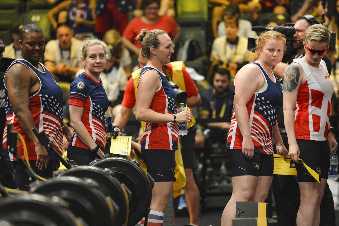 Left to right: Retired Army Sgt. Monica Southall, retired Army 2nd Lt. Jennifer Schuble, retired Army Staff Sgt. Randi Gavell and retired Navy Petty Officer 1st Class Shahnaz Askins walk onto the floor before competing in a rowing event during the 2016 Invictus Games in Orlando, Fla., May 9, 2016. Air Force photo by Tech. Sgt. Joshua L. DeMotts

