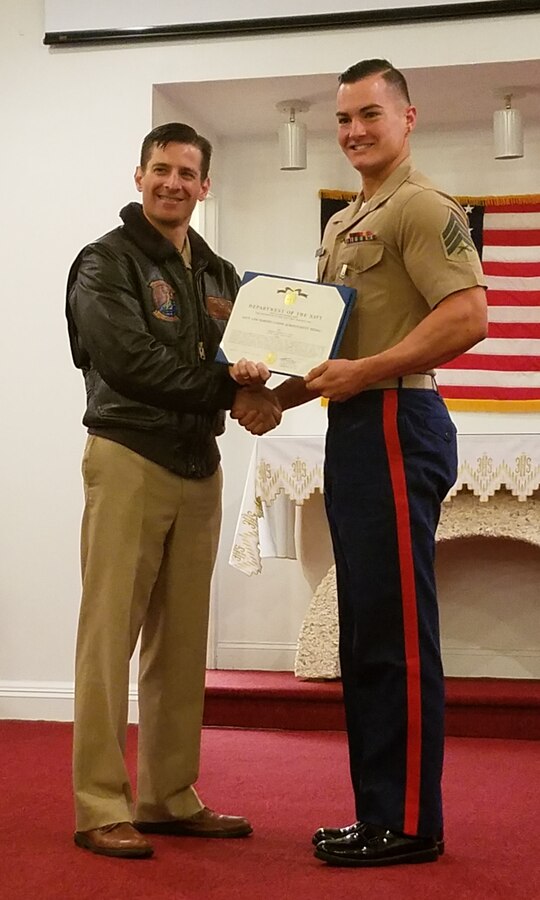 U.S. Navy Capt. Jay Steingold, left, presents U.S. Marine Corps Sgt. Zechariah Lund with a Navy and Marine Corps Achievement Medal May 3, 2016, at Naval Weapons Station Earle in Colts Neck, N.J. Lund received the award for training five sailors serving on the instillation’s security force up to black belt in the Marine Corps’ Martial Arts Program while strengthening the relationship between the Marines and sailors aboard the station. Steingold is the commanding officer for Naval Weapons Station Earle. Lund is the supply clerk for Recruiting Station New Jersey.
