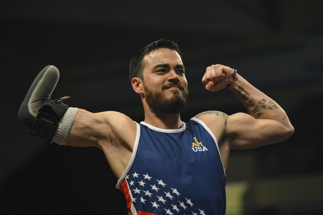 Retired Air Force Staff Sgt. Daniel Crane flexes as he hears his name before competing in rowing event during the 2016 Invictus Games in Orlando, Fla., May 9, 2016. Air Force photo by Tech. Sgt. Joshua L. DeMotts