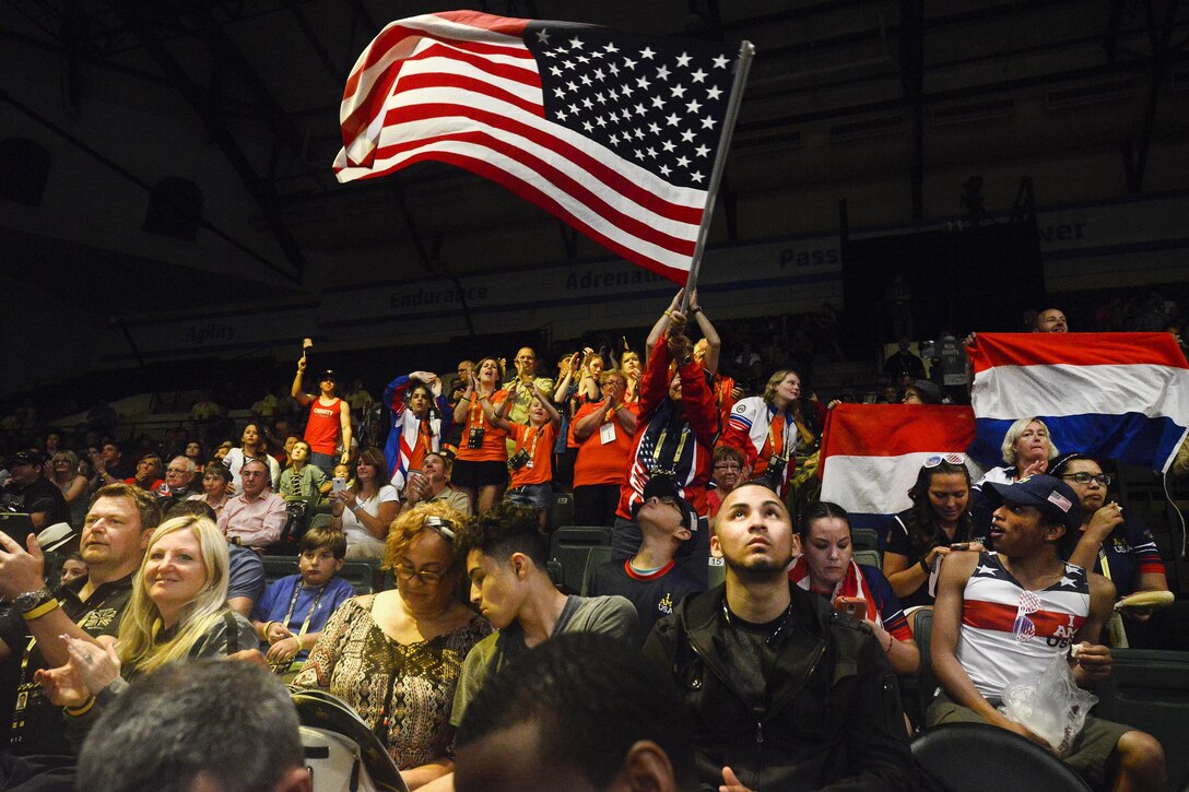 Fans cheer athletes competing in rowing events during the 2016 Invictus Games in Orlando, Fla., May 9, 2016. Air Force photo by Tech. Sgt. Joshua L. DeMotts