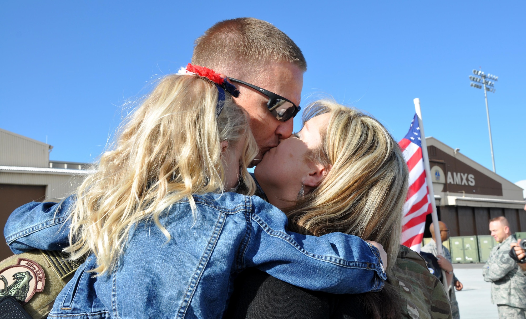 Tech. Sgt. Cliff Calhoun, a reservist in the 419th Aircraft Maintenance Squadron, embraces his wife and daughter upon returning from deployment to Afghanistan. About 300 Airmen from the active duty 388th Fighter Wing and Reserve 419th Fighter Wing returned to Hill Air Force Base on May 10. While deployed, the Airmen supported F-16 operations in the region as part of Operation Freedom’s Sentinel and NATO’s Resolute Support Mission. Most of the Airmen were deployed for six months. (U.S. Air Force photo/Bryan Magaña) 