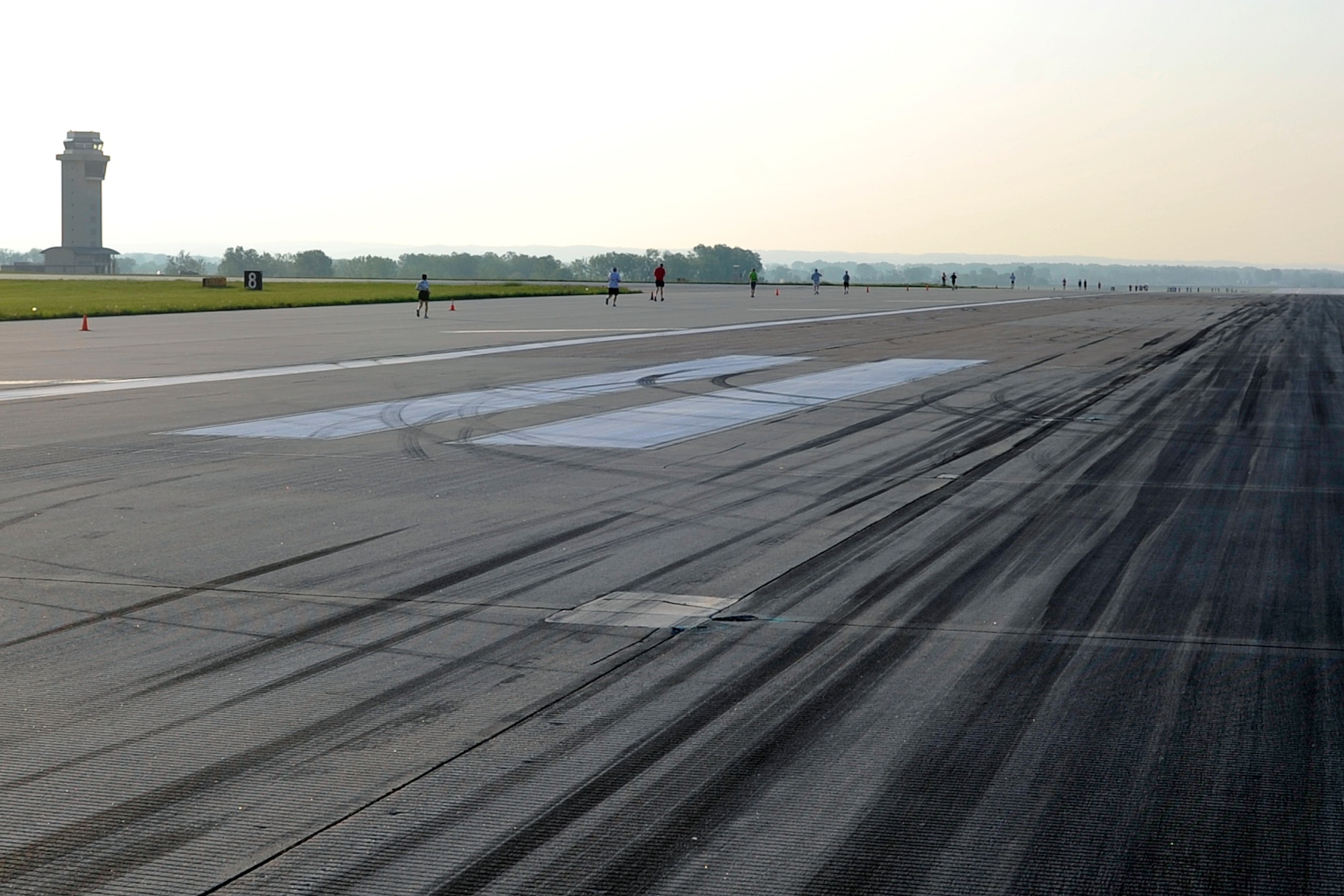 Participants follow close to cones on the flightline for the eighth annual Bellevue-Offutt Runway Run at Offutt Air Force Base, Neb., May 8, 2016. More than 100 runners participated in this unique seven-mile race that takes place on Mother’s Day each year. (U.S. Air Force photo by Jeff Gates)