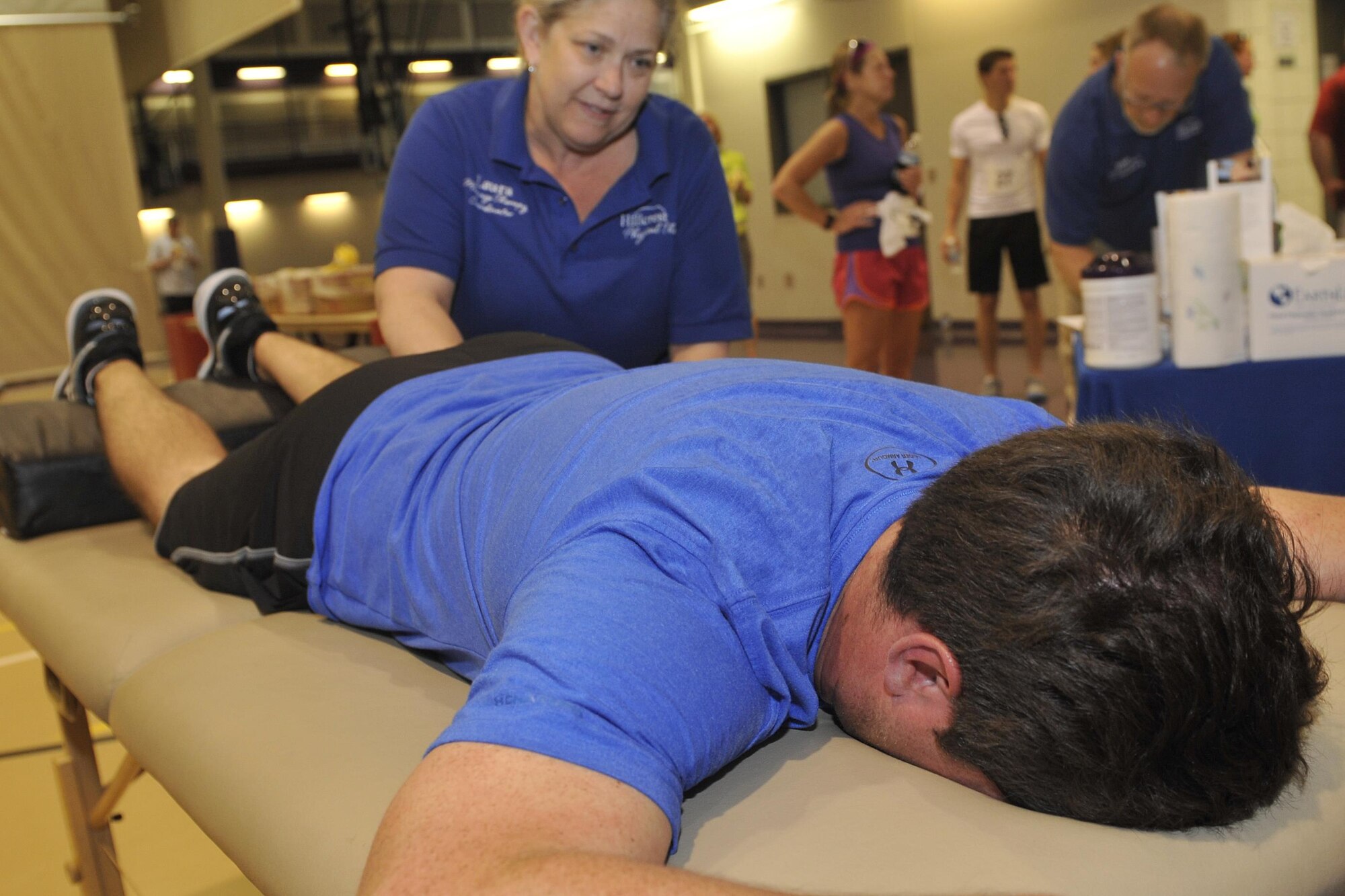 U.S. Air Force Capt. Joe Cunningham, of the 45th Reconnaissance Squadron, enjoys a complimentary massage after the eighth annual Bellevue-Offutt Runway Run at Offutt Air Force Base, Neb., May 8, 2016. Laura Black works out any post-race soreness courtesy of hillcrest physical therapy in Bellevue, Nebraska. More than 100 runners participated in this year’s event. (U.S. Air Force photo by Jeff Gates)