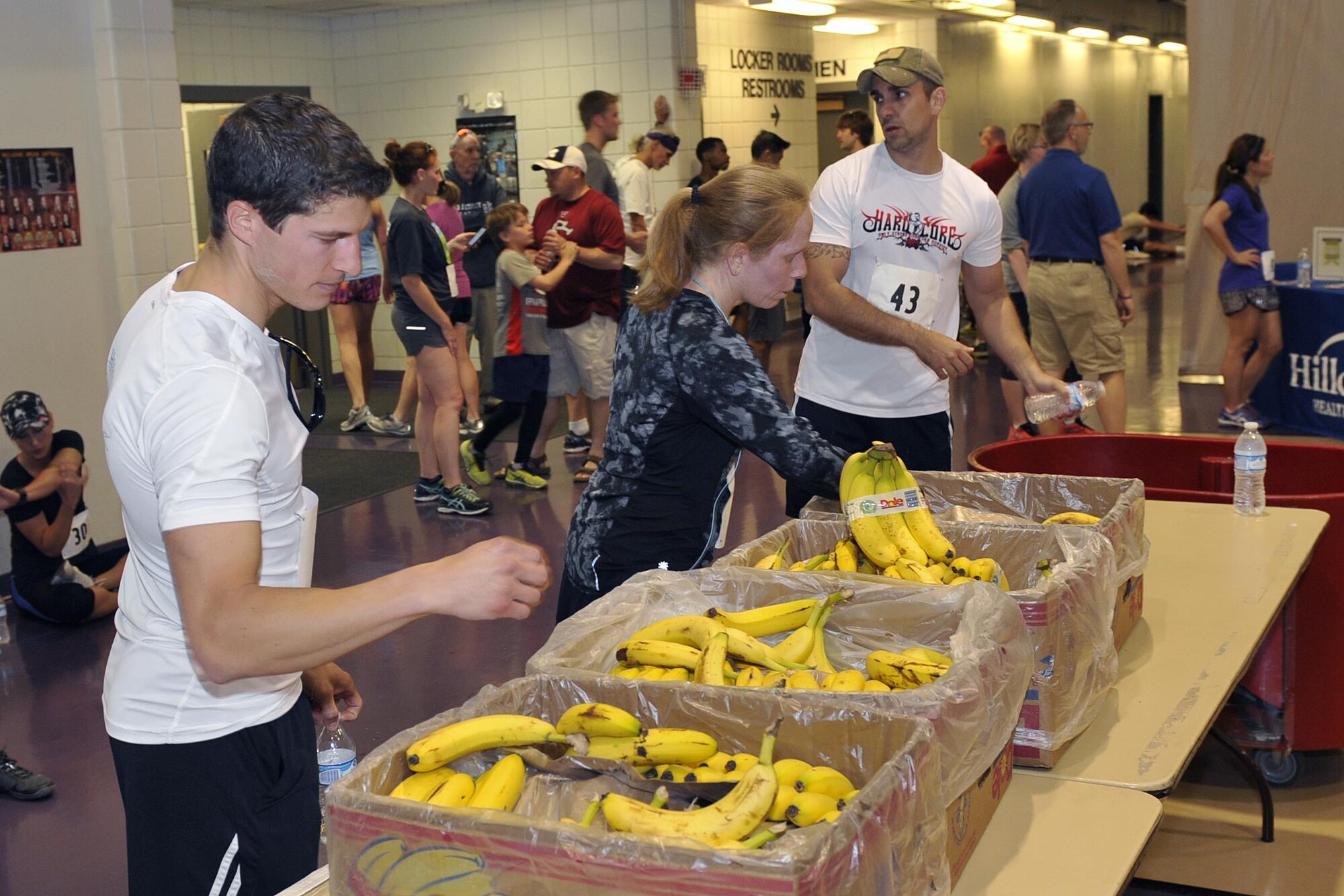Runners enjoy some bananas and cold water after the eighth annual Bellevue-Offutt Runway Run at Offutt Air Force Base, Neb., May 8, 2016. More than 100 runners participated in this seven-mile race. (U.S. Air Force photo by Jeff Gates)