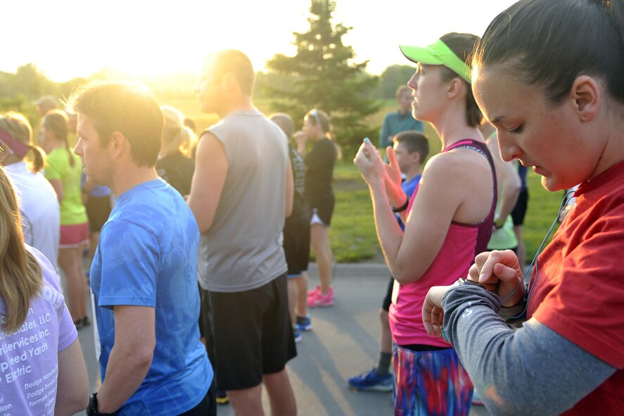 Runners check their watches as they prepare for the eighth annual Bellevue-Offutt Runway Run at Offutt Air Force Base, Neb., May 8, 2016. More than 100 runners participated in this unique seven-mile race that takes runners down Fort Crook road in Bellevue and on to Offutt where they run down an active U.S. Air Force runway. (U.S. Air Force photo by Jeff Gates)