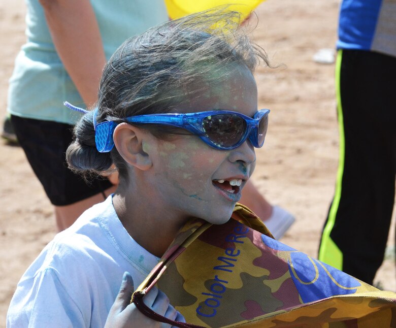 Mariah Mobley catches her breath after being doused with color during the America’s Armed Forces Kids Run at Schriever Air Force Base, Colorado, Friday, May 6, 2016. The powdered color participants ran through during the one-half or one-mile run were used to represent Child Abuse Prevention Month and Month of the Military Child. (U.S. Air Force photo/Brian Hagberg)