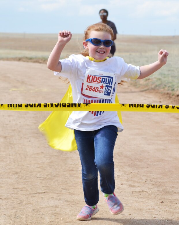 Sarah Ford crosses the finish line during the America’s Armed Forces Kids Run at Schriever Air Force Base, Colorado, Friday, May 6, 2016. Ford, along with more than 30 other runners participated in the annual event designed to commemorate Month of the Military Child and Child Abuse Prevention Month. (U.S. Air Force photo/Brian Hagberg)