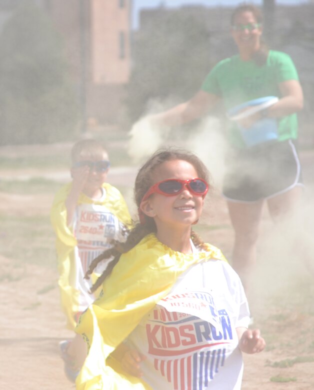 Zoe Allen emerges through the color fog during the annual America’s Armed Forces Kids Run at Schriever Air Force Base, Colorado, Friday, May 6, 2016. Allen was one of the more than 30 runners who participated in the event. (U.S. Air Force photo/Brian Hagberg)