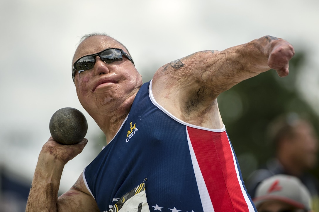 Air Force Master Sgt. Israel Del Toro throws a shot put during the 2016 Invictus Games in Orlando, Fla., May 10, 2016. DoD photo by EJ Hersom