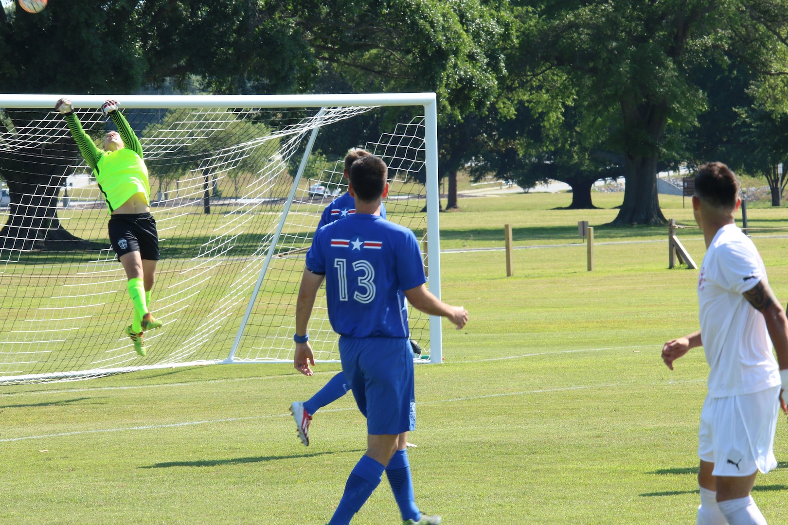 Air Force Goal Keeper Airman 1st Class Kerry Segebart(left) leaps to save a near goal by Marine Corps.  Air Force defeated Marine Corps 5-0 in Match One of the Armed Forces Men's Soccer Championship at Fort Benning, Ga, 6-14 May 2016.