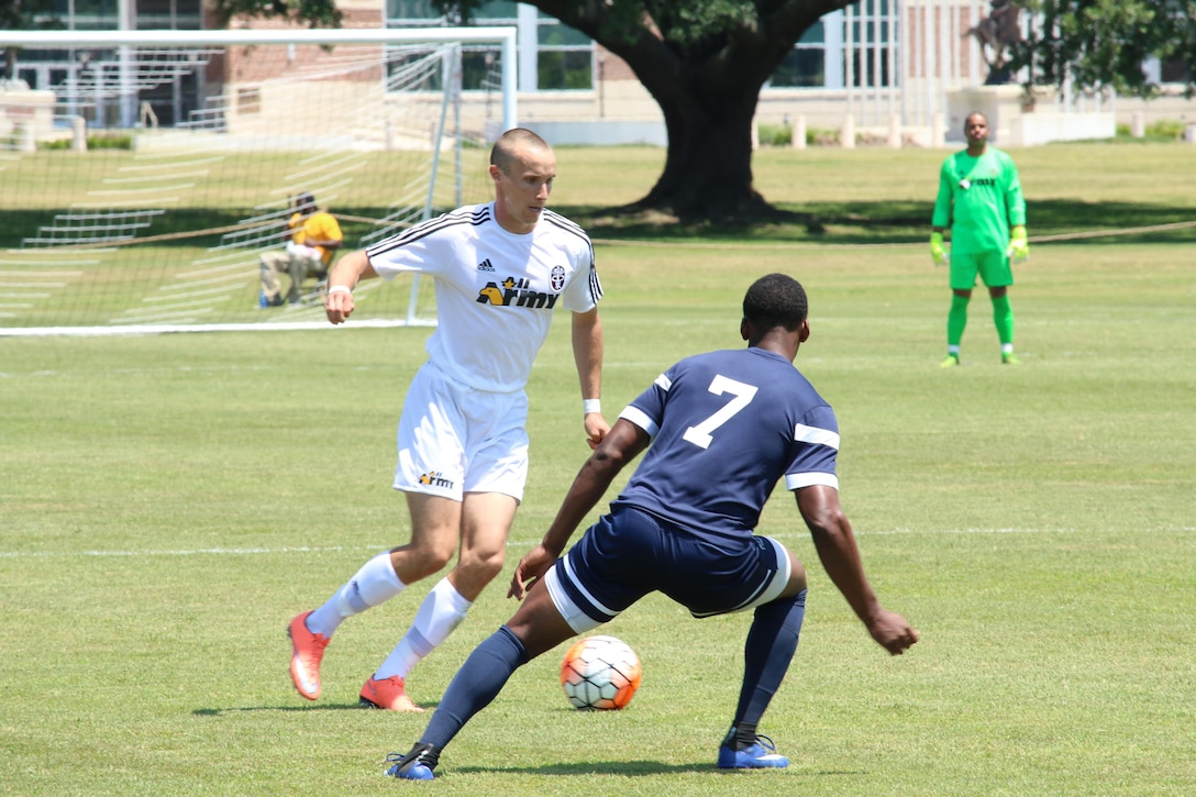 Army Sgt. Joseph Karslo (left) moves past Navy's Petty Officer 2nd Class Kyle Baker (#7).  Army defeated Navy 2-0 in Match Two of the Armed Forces Men's Soccer Championship at Fort Benning, Ga, 6-14 May 2016.