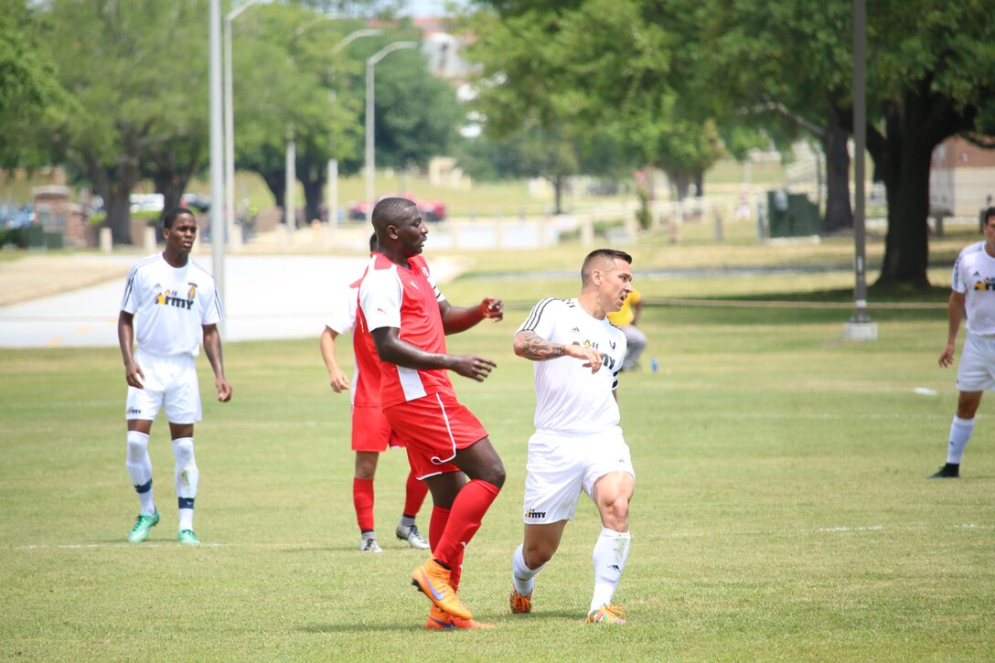 Marine Cpl. Adrian Brown (Left-Red) hits the go-ahead goal against Army to defeat them 1-0 in Match Four of the Armed Forces Men's Soccer Championship at Fort Benning, Ga, 6-14 May 2016.