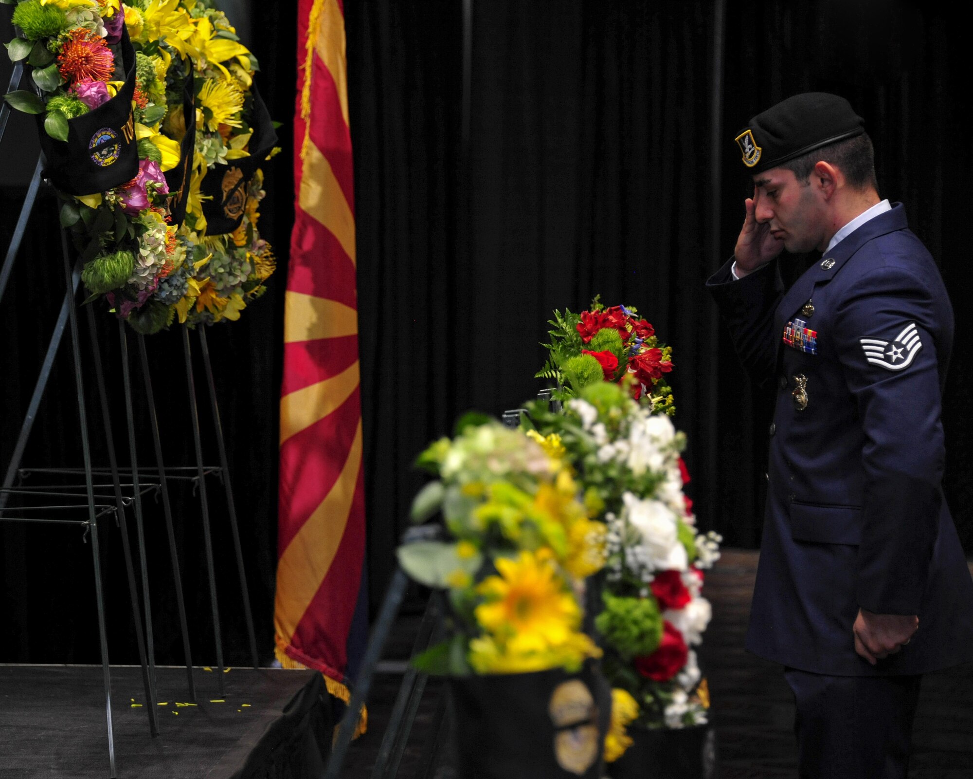 U.S. Air Force Staff Sgt. Raffi Stambultsyan, 355th Security Forces Squadron member, salutes a wreath during the 9th Annual Pima County Regional Law Enforcement Memorial at the Tucson Convention Center in Tucson, Ariz., May 6, 2016.  The memorial was held to honor local members of law enforcement who lost their lives while serving in the line of duty.  (U.S. Air Force photo by Senior Airman Chris Massey/Released)