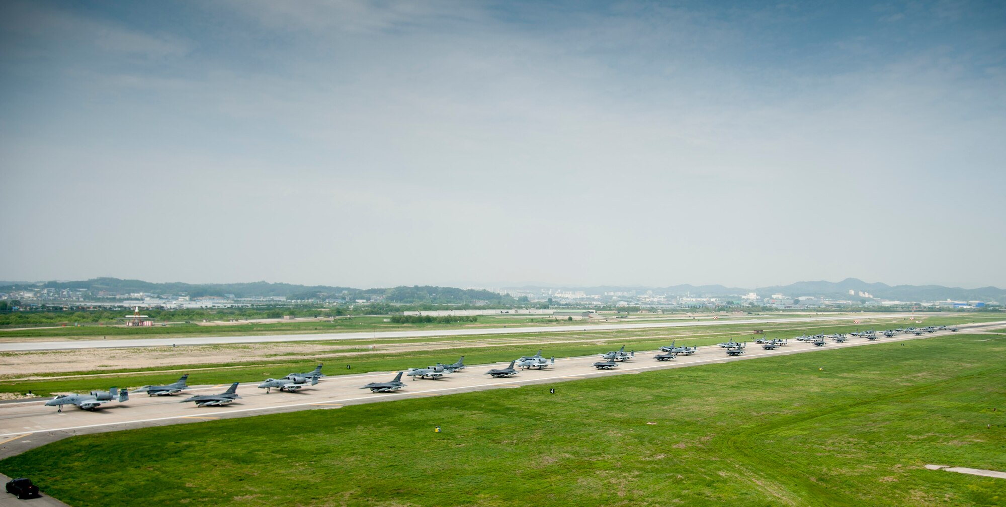A-10 Thunderbolt II and F-16 Fighting Falcon fighter aircraft perform an 'Elephant Walk' on the runway this week during Exercise Beverly Herd 16-01 at Osan Air Base, Republic of Korea. The Elephant Walk was a demonstration of U.S. Air Force capabilities and strength and showcases the wing's ability to generate combat airpower in an expedient manner in order to respond to simulated contingency operations. The A-10 Thunderbolt II aircraft are the 25th Fighter Squadron "Draggins" and the F-16 Fighting Falcon aircraft are the 36th Fighter Squadron "Friends" from the 51st Fighter Wing, Osan AB, ROK; the additional F-16 aircraft are the 179th Fighter Squadron "Bulldogs" from the 148th Fighter Wing out of Duluth Air National Guard Base, Minnesota.(U.S. Air Force photo by Staff Sgt. Jonathan Steffen/Released)
