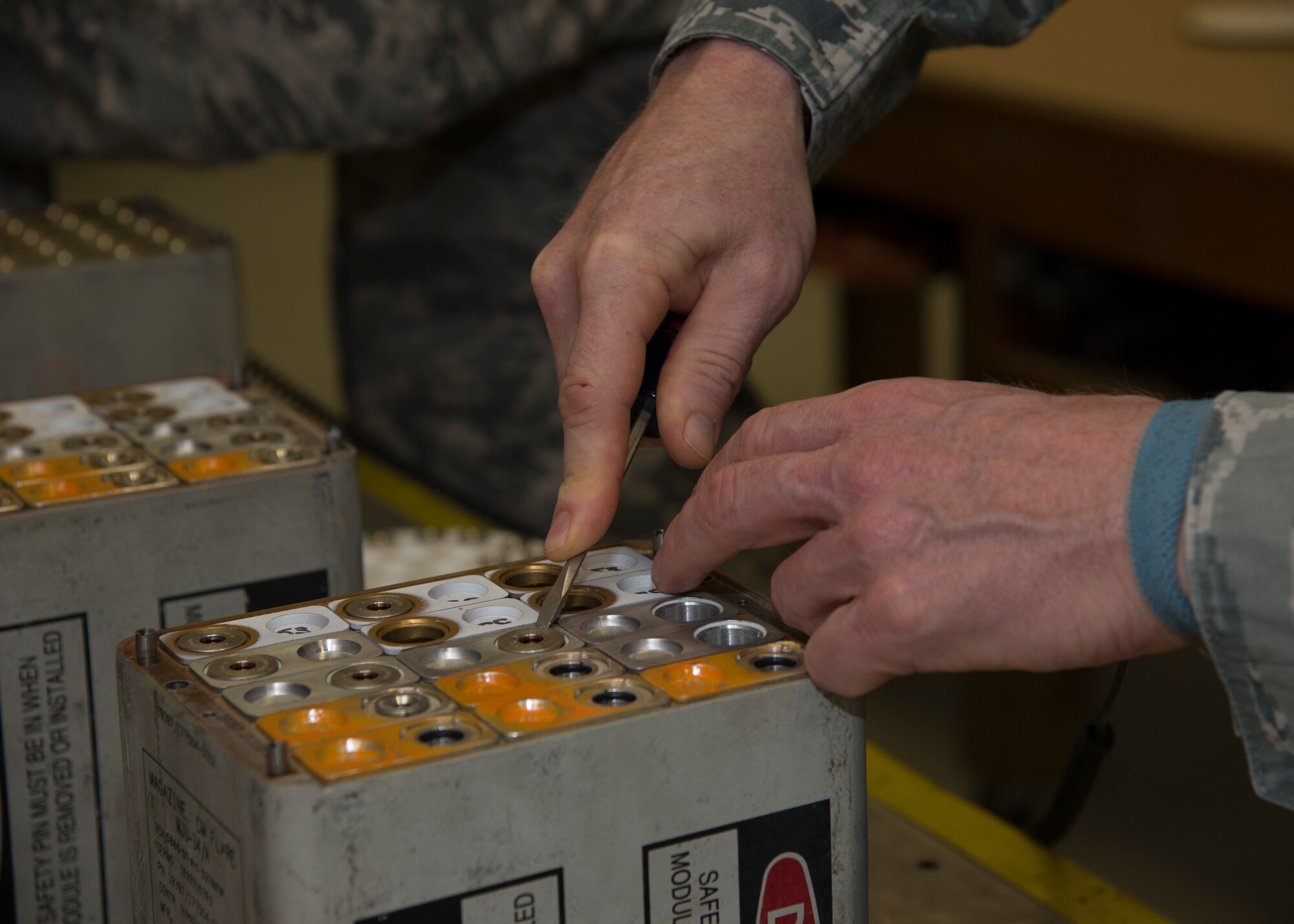 Col. Michael Grismer, 436th Airlift Wing commander, removes the firing primer on an aircraft flare stick May 4, 2016, at Dover Air Force Base, Del. Grismer takes time every week to visit Team Dover units and Airmen who serve under his command. (U.S. Air Force photo/Senior Airman Zachary Cacicia)