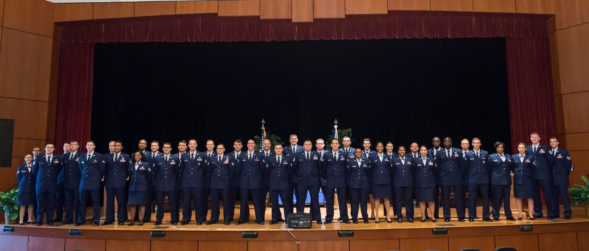 Forty Airmen pose for a group photo during a Community College of the Air Force graduation ceremony May 6, 2016, at Joint Base Charleston, S.C. CCAF was established April 1, 1972 and provides enlisted Airmen a regionally accredited degree through the Air University by the Southern Association of Colleges and Schools. (U.S. Air Force photo/Staff Sgt. Jared Trimarchi)
  
