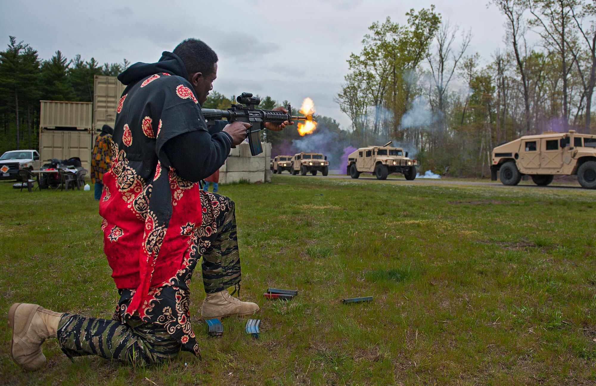 Staff Sgt. Evans Adonteng, 421st Combat Training Squadron instructor, fires on a convoy carrying honorary Air Mobility Command commanders during a mock attack at the Air Force Epxpeditionary Command's Training Village. The honorary commanders toured the joint base along with Gen. Carlton D. Everhart II, AMC commander and AMC Chief Master Sgt. Shelina Frey April 27.