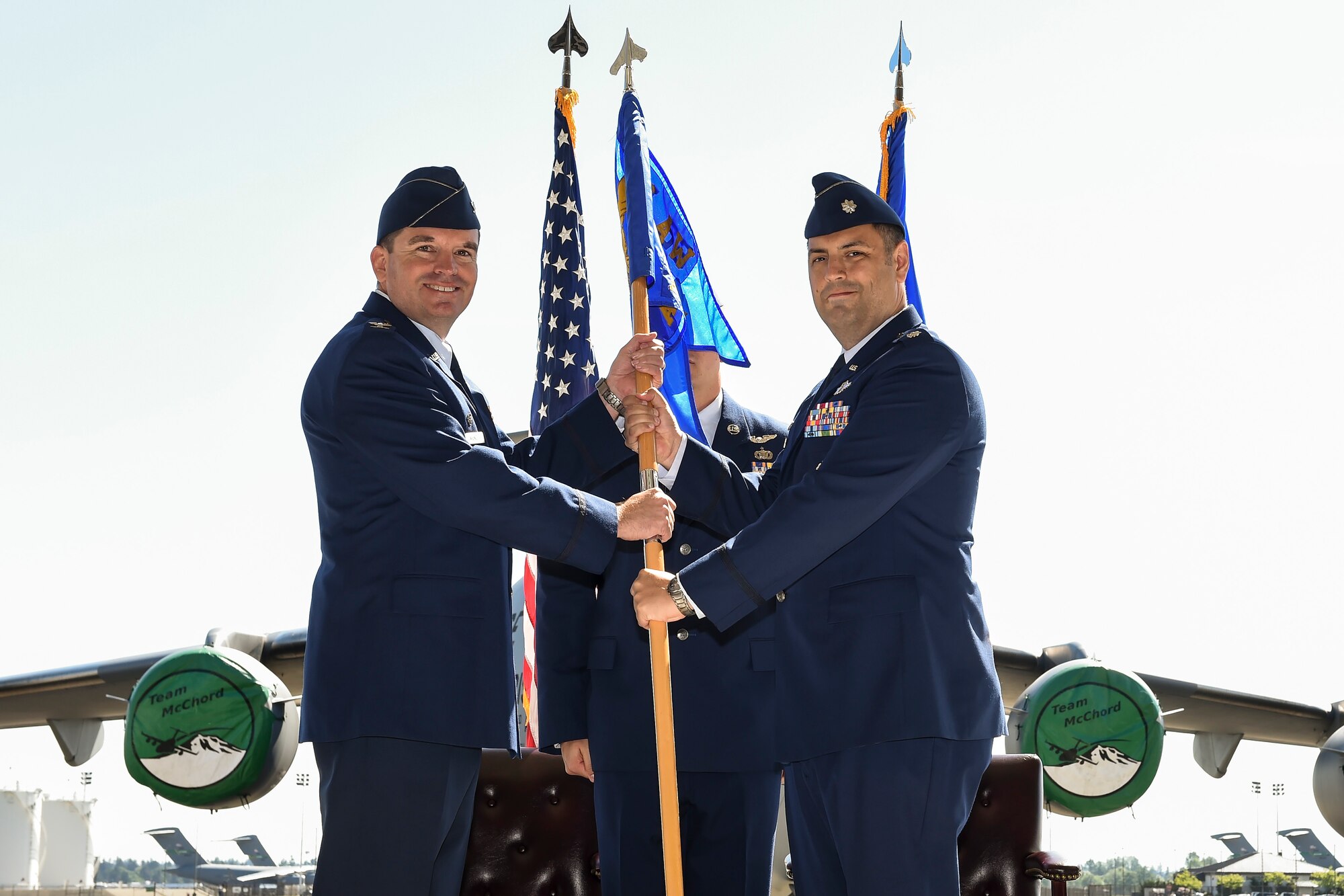 Lt. Col. Nathan Campbell (right), former 10th Airlift Squadron Commander, passes the 10th AS guidon to Col. David Owens (left), 62nd Operations Group commander May 6, 2016, during the 10th AS inactivation ceremony at Joint Base Lewis-McChord, Wash. The passing of the guidon signified the official inactivation of the unit. (U.S. Air Force photo/Tech. Sgt. Sean Tobin)
