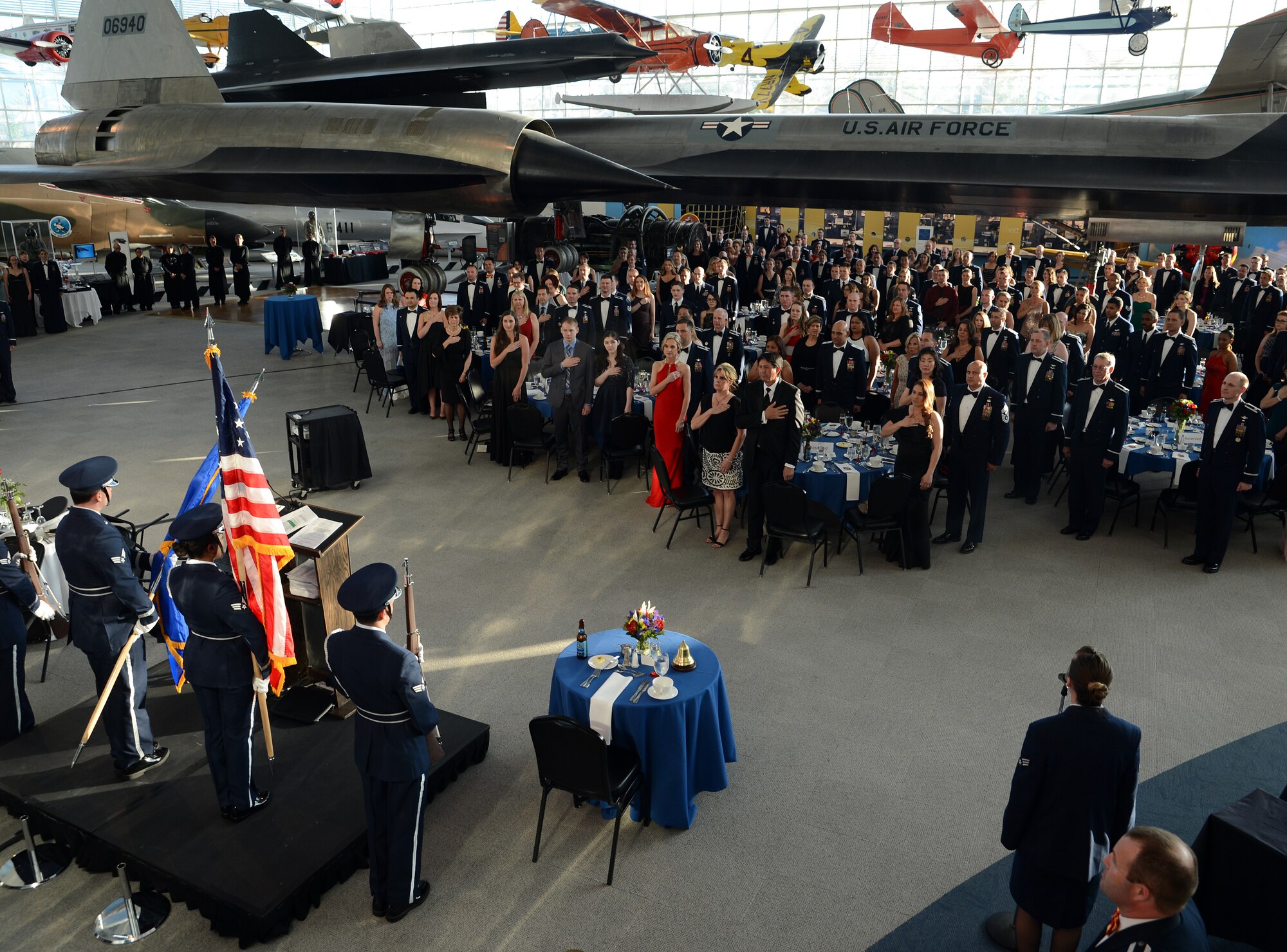 Team McChord Airmen, civic leaders and guests show their respect during the singing of the National Anthem at the 10th AS 75th Anniversary Heritage Gala May 6, 2016, at the Museum of Flight in Seattle, Wash. In its nearly 13 years based at McChord Field the 10th AS, also known as the “Pathfinders,” took part in missions all over the world. (U.S. Air Force photo/Senior Airman Jacob Jimenez)