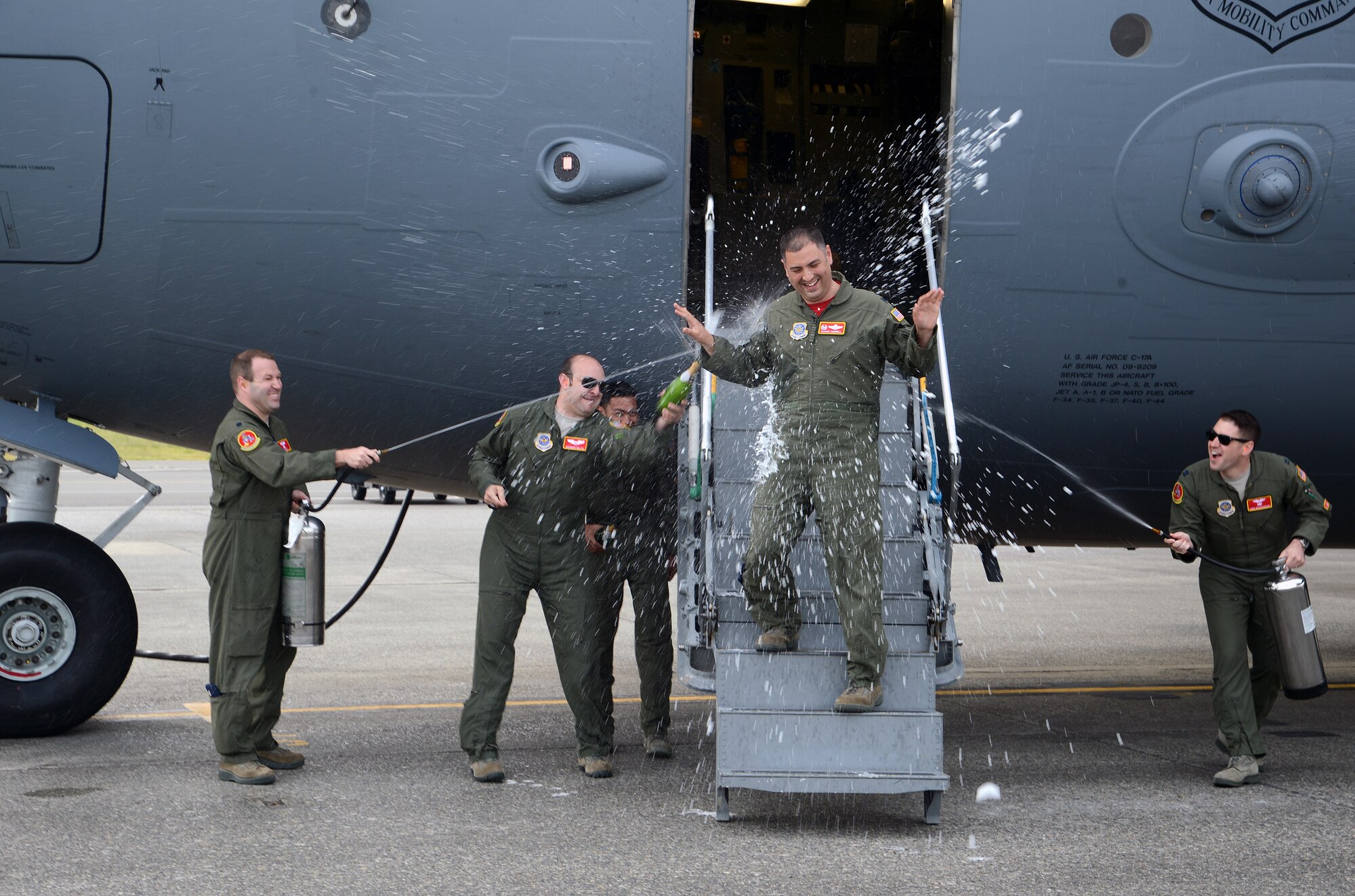 Lt. Col. Nathan Campbell, 10th Airlift Squadron commander, laughs at being sprayed with water after flying his last flight as commander of the 10 AS prior to the unit’s inactivation, May 3, 2016, at Joint Base Lewis-McChord, Wash. As part of an Air Force tradition among pilots, aircraft commanders are sprayed with water after flying their last flight, called a fini flight. For the fifth time in its 76-year history, the 10th AS was inactivated in a ceremony here May 6, 2016.(U.S. Air Force photo/Senior Airman Jacob Jimenez) 