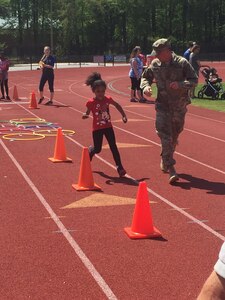 U.S. Army Soldiers from the 689th Rapid Port Opening Element help special needs children through obstacles at the 45th Annual George Green Field Day at Todd Stadium in Newport News, Virginia, April 25, 2015.  The RPOE has volunteered for the field day for the past five years as a way to give back to the local community . (U.S. Army courtesy photo)
