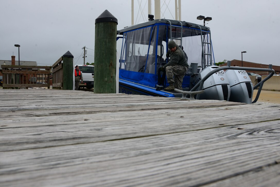 U.S. Airmen assigned to the 633rd Security Forces Squadron learn about the new SFS patrol boat at Langley Air Force Base, Va., May 5, 2016. The SFS Airmen will work with the Hampton Police Division to patrol the waters surrounding Langley. (U.S. Air Force photo by Senior Airman Kristina LaCoste)