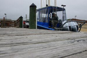 U.S. Airmen assigned to the 633rd Security Forces Squadron learn about the new SFS patrol boat at Langley Air Force Base, Va., May 5, 2016. The SFS Airmen will work with the Hampton Police Division to patrol the waters surrounding Langley. (U.S. Air Force photo by Senior Airman Kristina LaCoste)