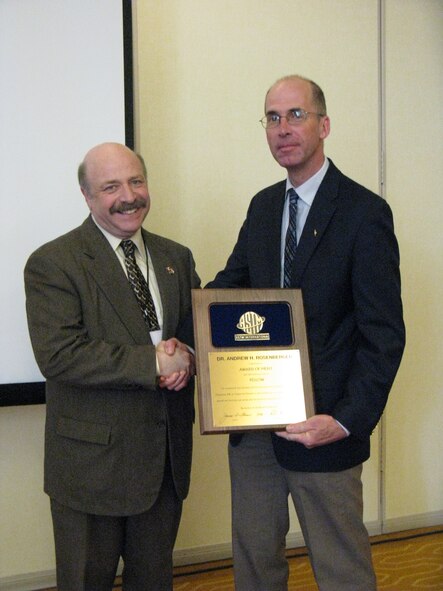 ASTM International Chairman Dr. Ralph Paroli (left) presents AFRL materials engineer Dr. Andrew Rosenberger with the ASTM International Award of Merit for his distinguished service and exceptional committee work in the area of metals fatigue and fracture.  (U.S. Air Force Photo/Steve Thompson)
