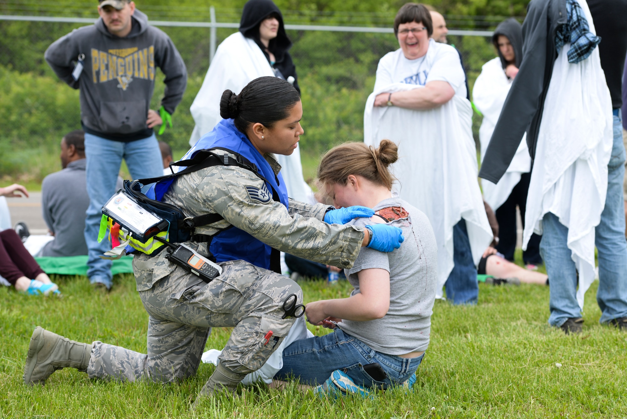 Staff Sgt. Jhosselin Alonzo, 88th Medical Operations Squadron paramedic triages Airman 1st Class Chloe Ingram, National Air and Space Intelligence Center scientific applications technician, during a mass casualty exercise at Wright-Patterson Air Force Base, May 5. During a mass casualty, people are triaged and assigned a color based on the severity of their wounds, enabling those wounded worst to be treated first. (U.S. Air Force photo/Wesley Farnsworth)