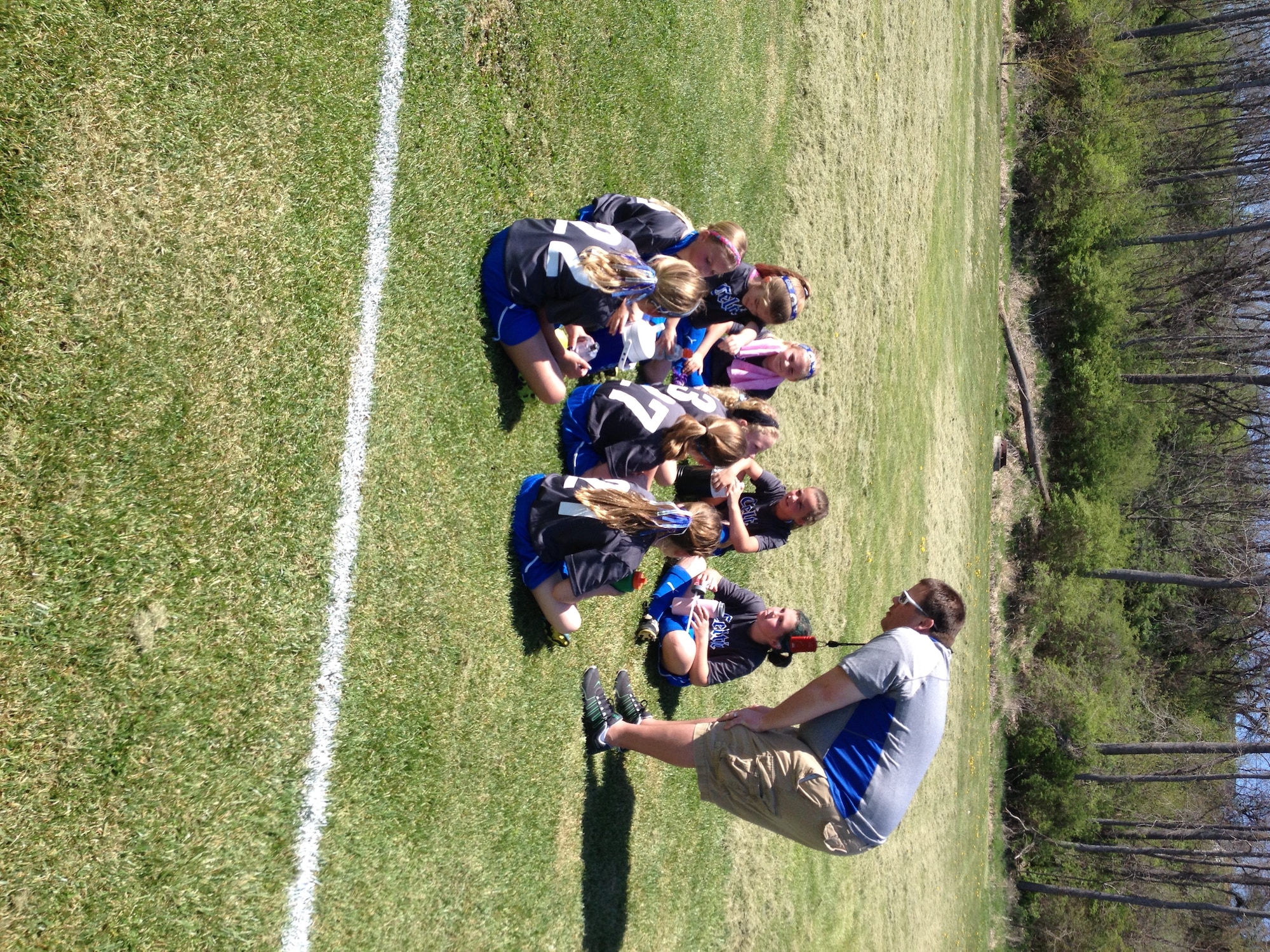 Coach Neal Wamsley instructs the girls’ soccer team on effective tactics of the game.  (U.S. Air Force photo/Sandy Simison)