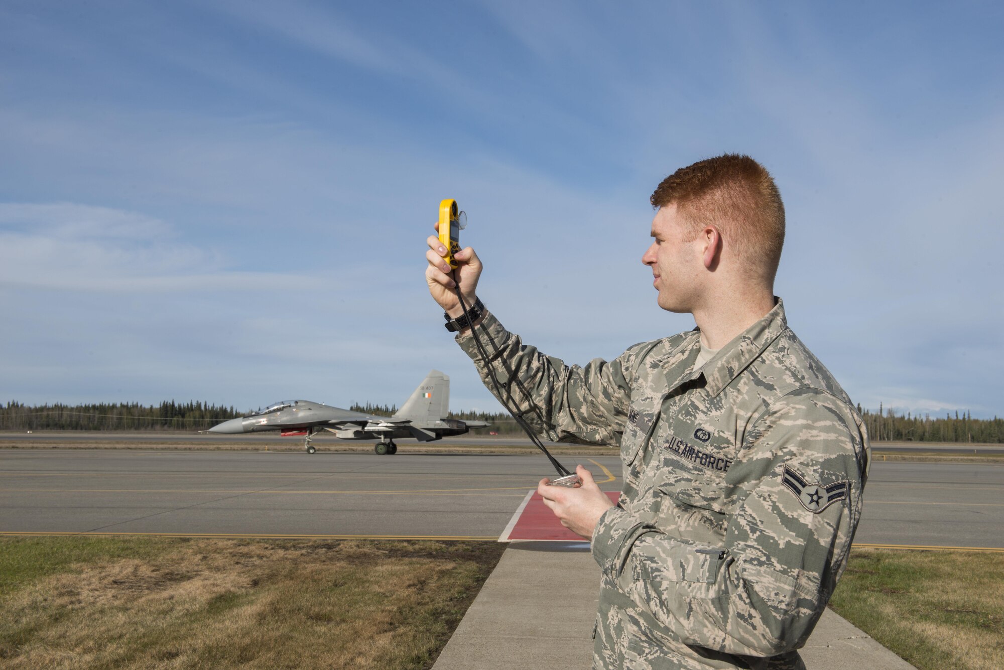 U.S. Air Force Airman 1st Class Rex Akins, a 354th Operations Support Squadron (OSS) weather technician, uses a Kestrel 4500 to capture weather conditions, May 4, 2016, at Eielson Air Force Base, Alaska. The 354 OSS weather flight records and passes along weather information to augmentees from the 18th OSS to build briefing slides for pilots during RED FLAG-Alaska 16-1. (U.S. Air Force photo by Staff Sgt. Ashley Nicole Taylor/Released)