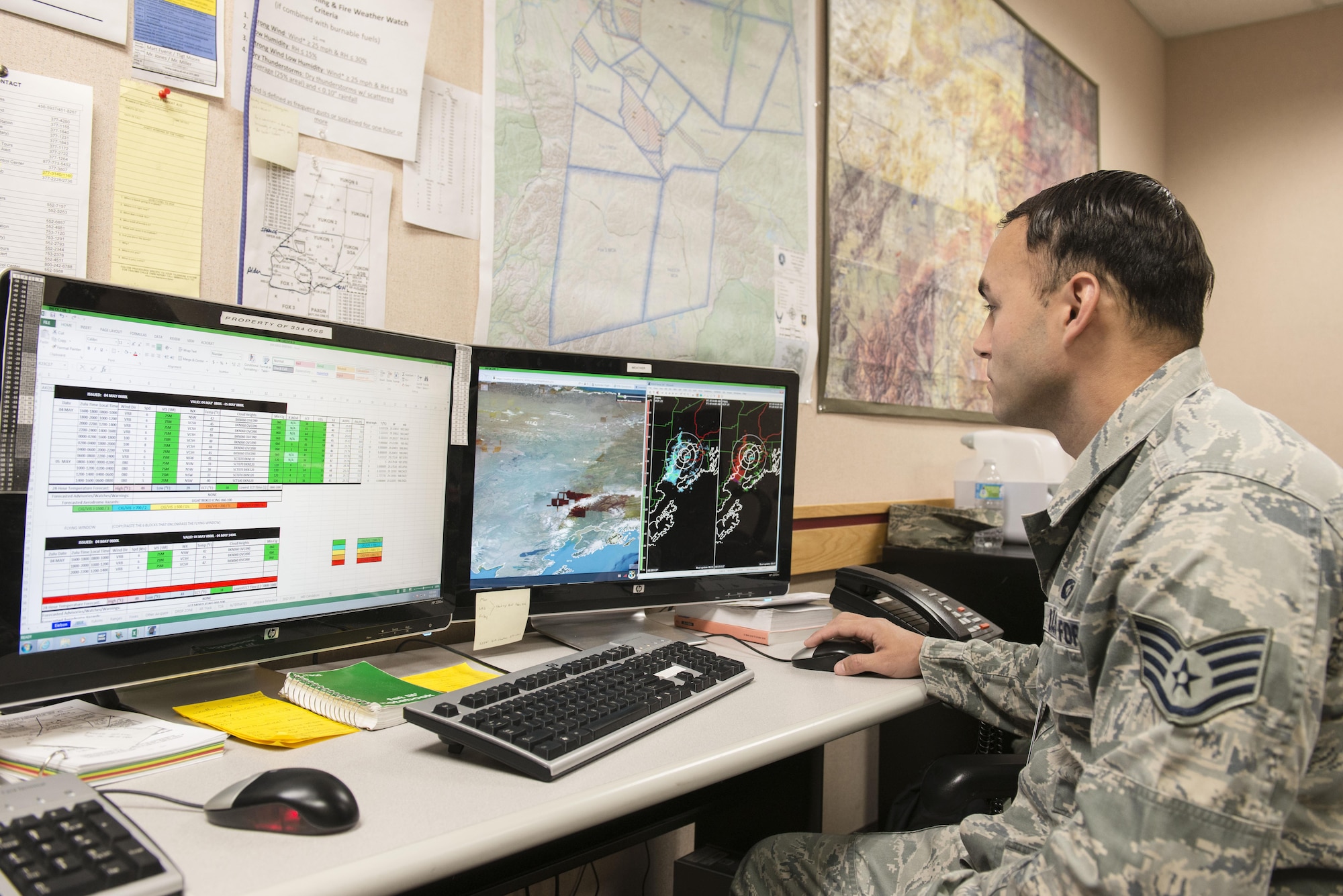 U.S. Air Force Staff Sgt. Joey Putis, an 18th Operations Support Squadron (OSS) weather technician assigned to Kadena Air Base, Japan, checks weather conditions to build a briefing slide, May 4, 2016, at Eielson Air Force Base, Alaska. Putis works with members from the 354th OSS to deliver accurate weather conditions to pilots participating in RED FLAG-Alaska 16-1 from Eielson and Joint Base Elmendorf-Richardson. (U.S. Air Force photo by Staff Sgt. Ashley Nicole Taylor/Released)