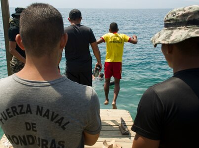 An enlisted Honduran Navy trainee jumps in the water during a swimming aptitude test April 4, 2016, on the northern coast of Honduras. The trainees took part in the first ever consolidated infantry training program in the Navy, giving them a common set of skills and knowledge to pull from in the future. (U.S. Air Force photo by Capt. Christopher Mesnard)