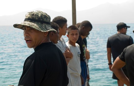 A Honduran Navy trainer calls for the next group of enlisted trainees during a swimming aptitude test April 4, 2016, on the northern coast of Honduras. The trainees took part in the first ever consolidated infantry training program in the Navy, giving them a common set of skills and knowledge to pull from in the future. (U.S. Air Force photo by Capt. Christopher Mesnard)