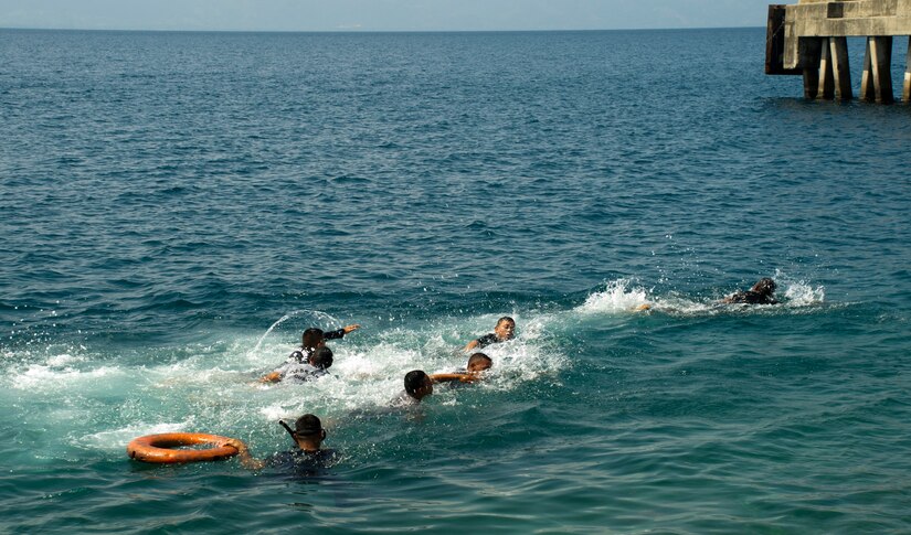 Enlisted trainees with the Honduran Navy participate in a swimming test April 4, 2016, on the northern coast of Honduras, to determine their skill level in the water. The swimming test is used to help determine the amount of additional training the members require during the XX-week basic infantry course. (U.S. Air Force photo by Capt. Christopher Mesnard)